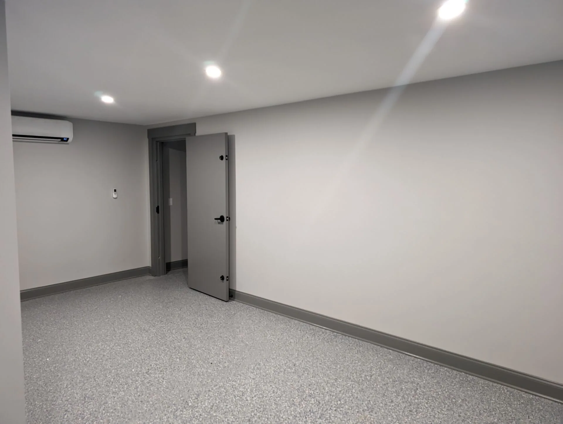 Finished basement room alternate view with finished door and matched flooring