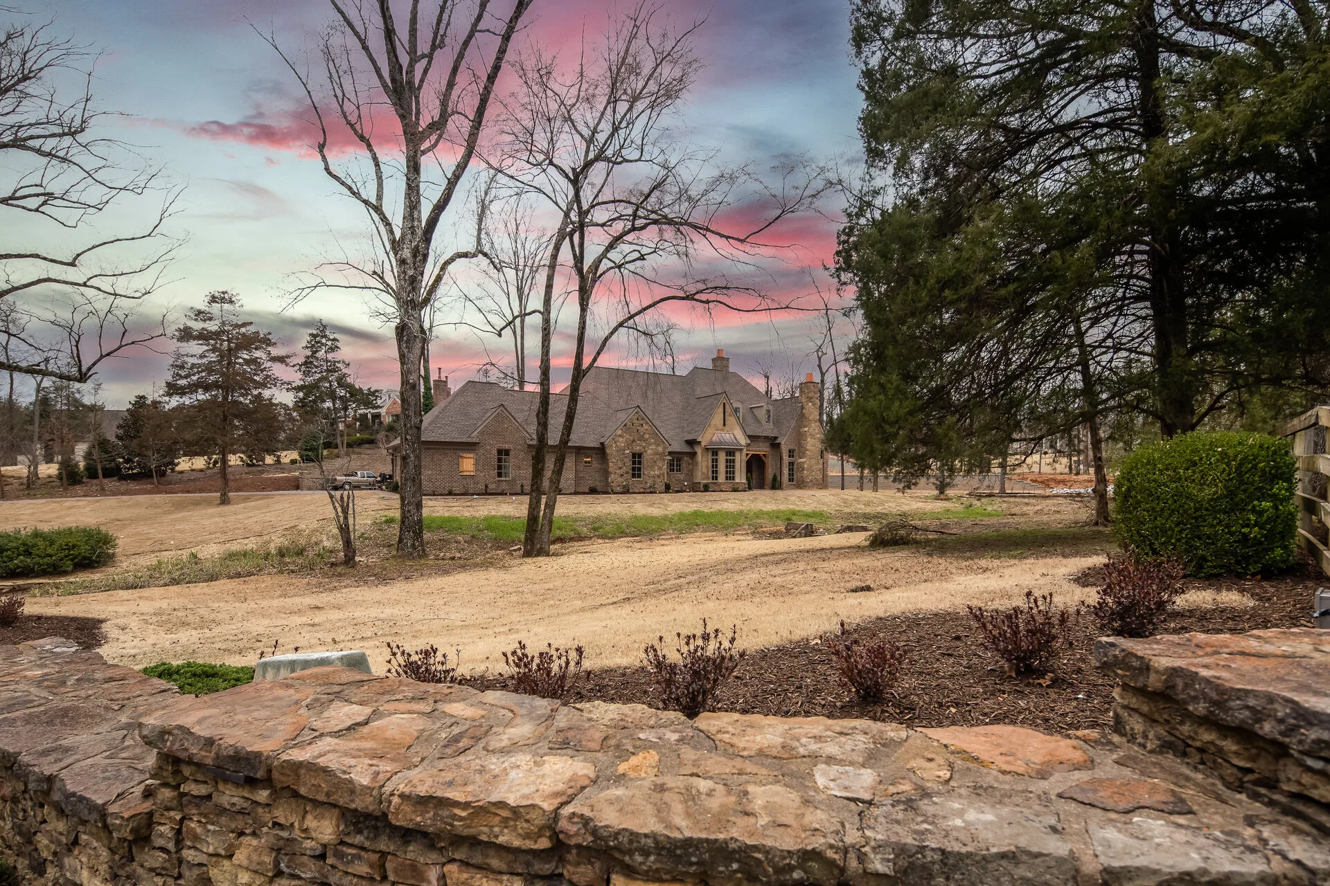 Custom stone residence at twilight — Harber Built West Tennessee
